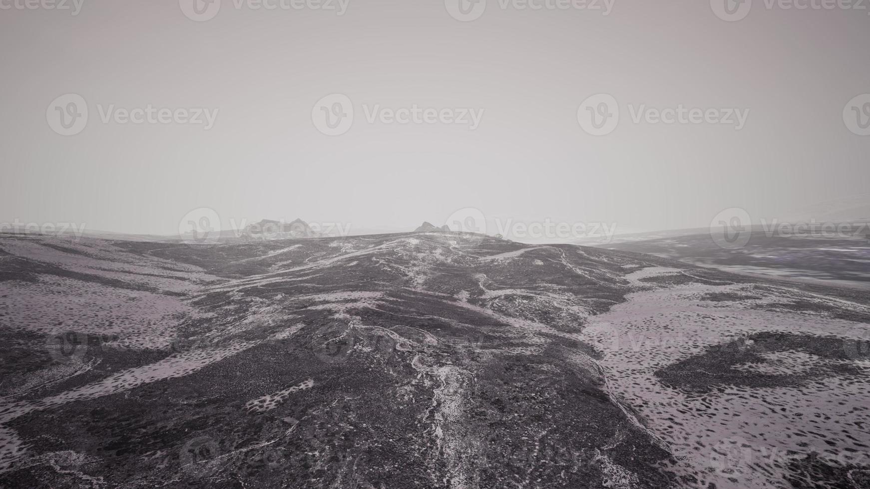 Dramatic winter dark desert steppe on a highland mountain plateau photo