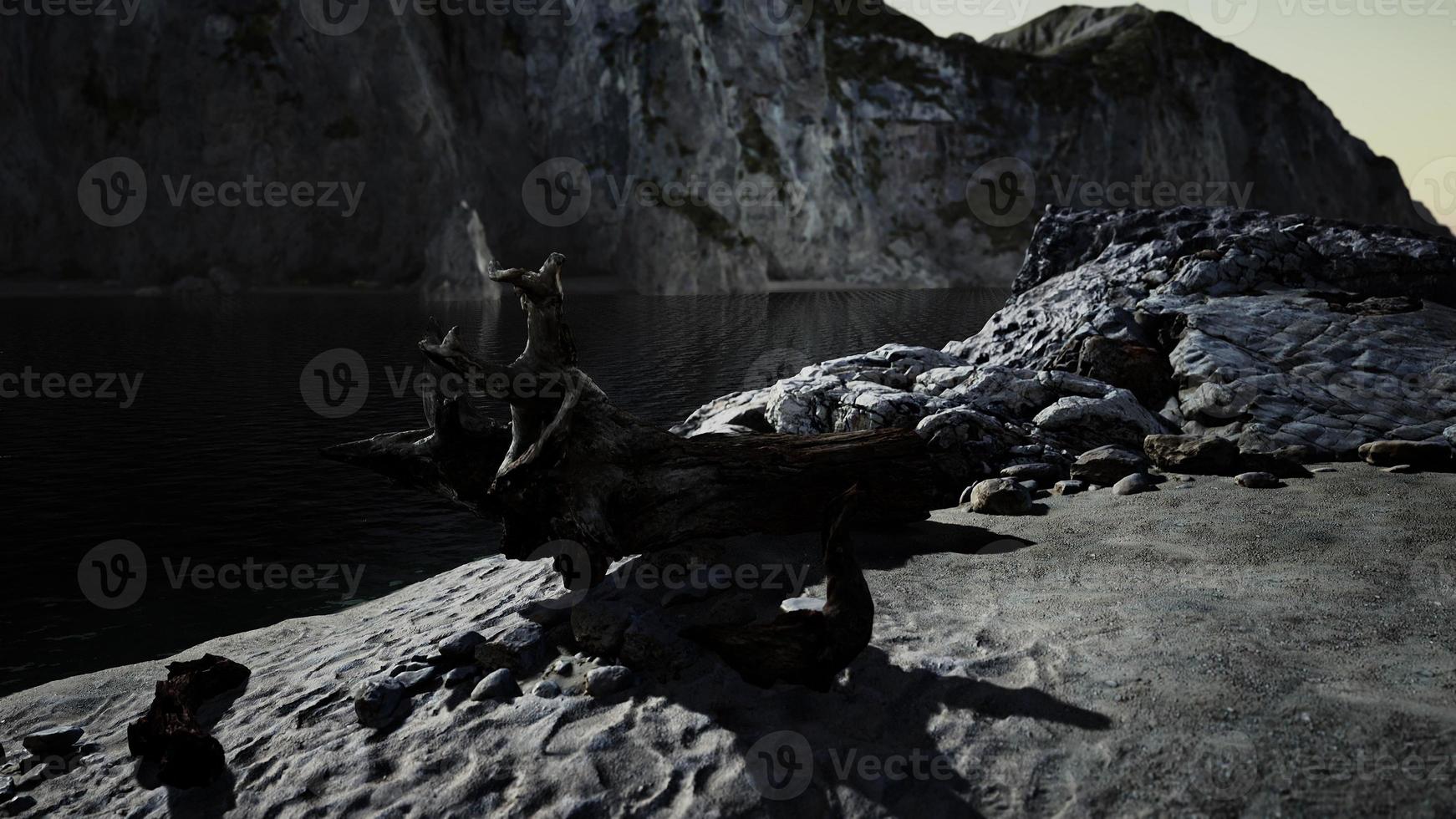 Black sand beach hidden between blurred volcanic rocks photo