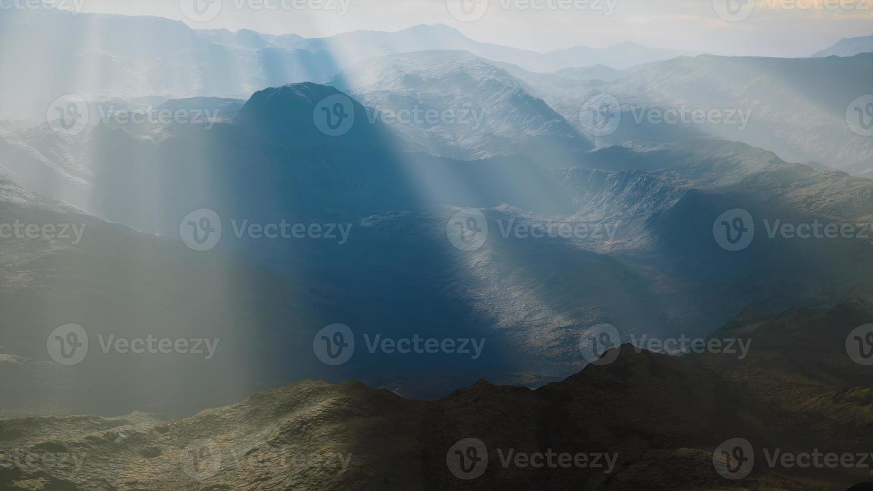 Alpine chains shrouded in the morning fog photo