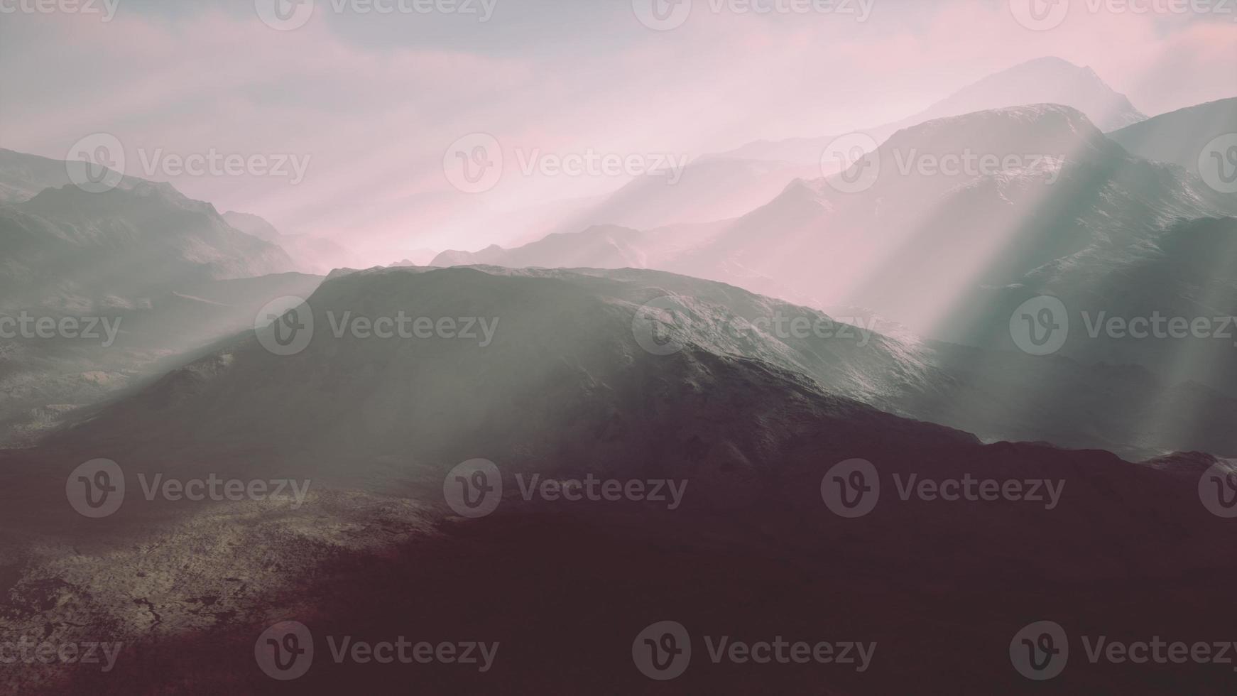 Alpine chains shrouded in the morning fog photo