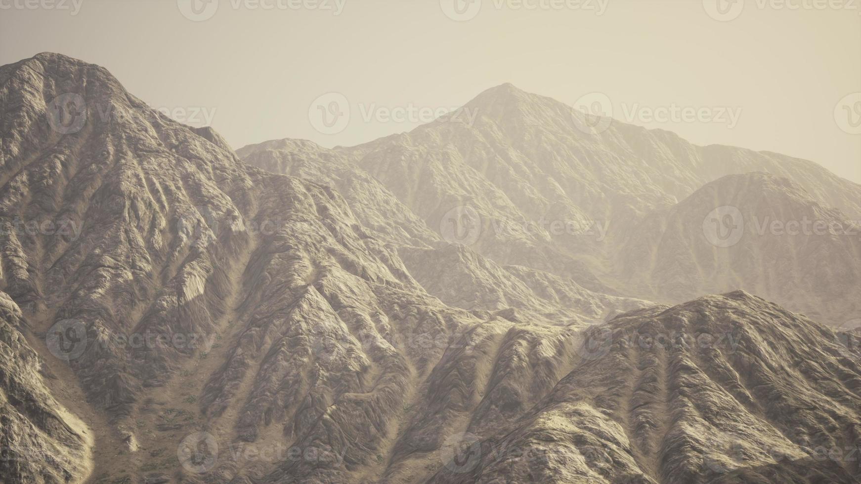 View of the Afghan mountains in fog photo