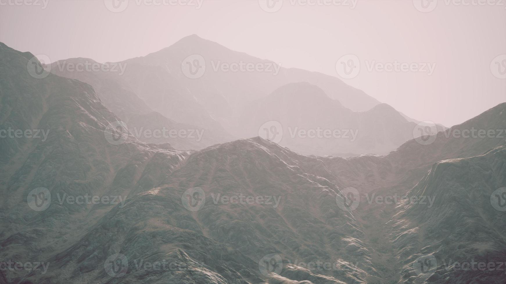 View of the Afghan mountains in fog photo