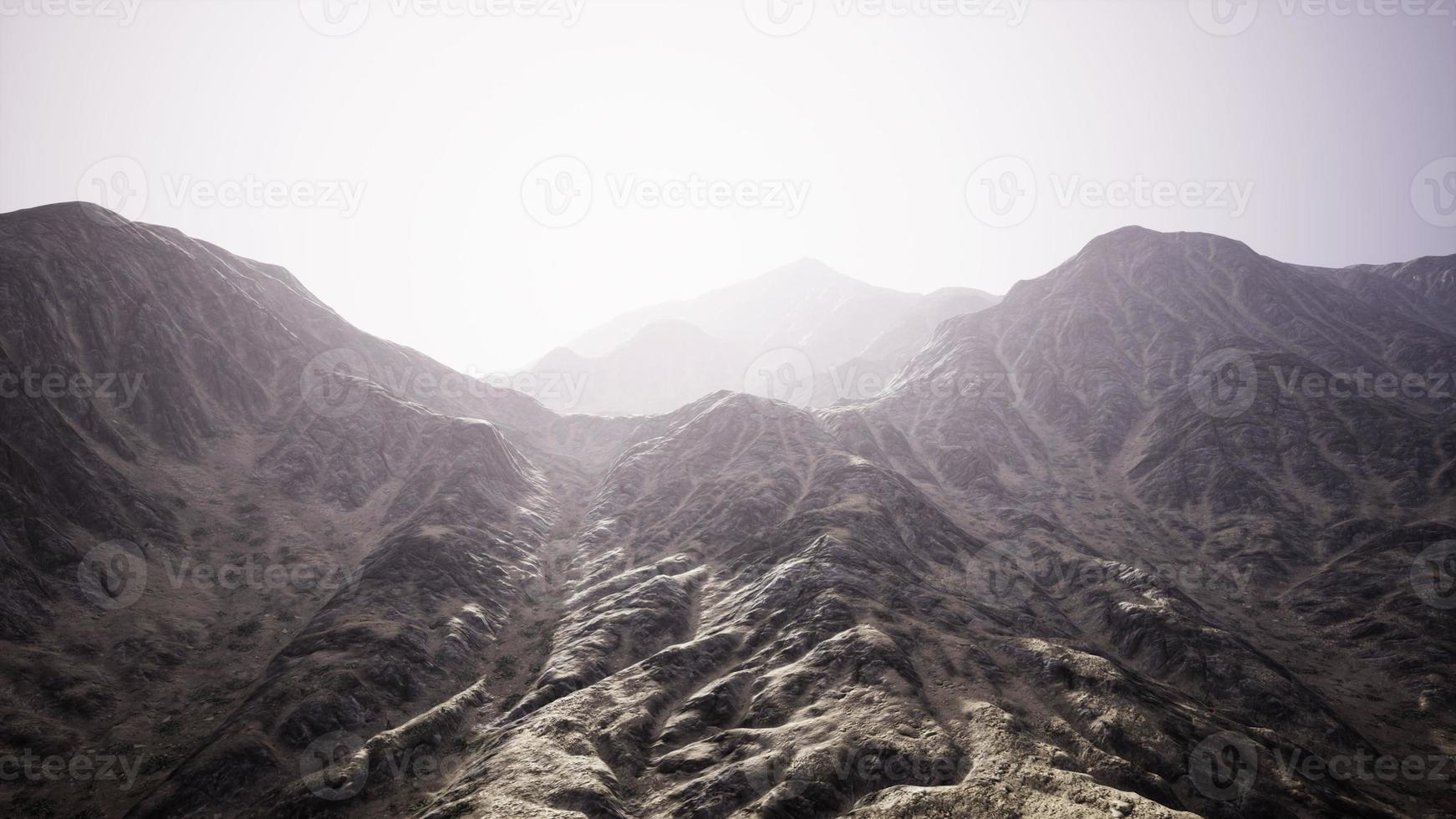 View of the Afghan mountains in fog photo