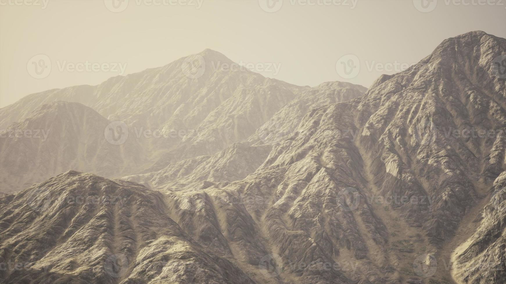 View of the Afghan mountains in fog photo