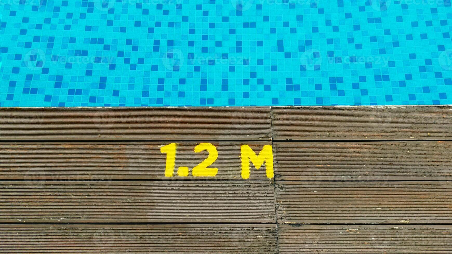 Deck of swimming pool edge 1.2 meter deep sign. photo