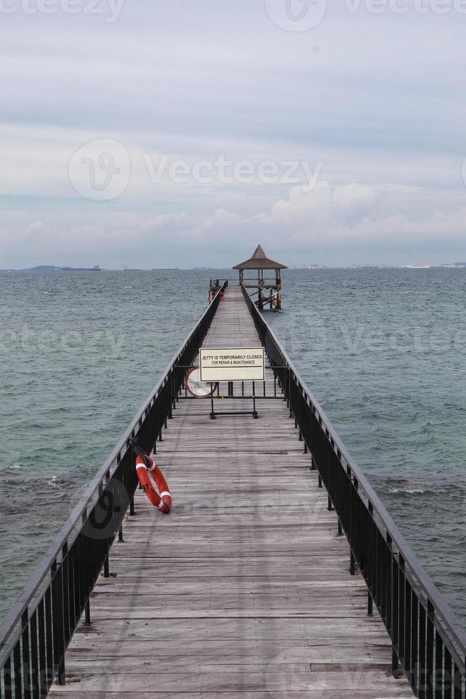 Fishing piers or boardwalk jetty at the seaside or resort being closed at the moment. photo