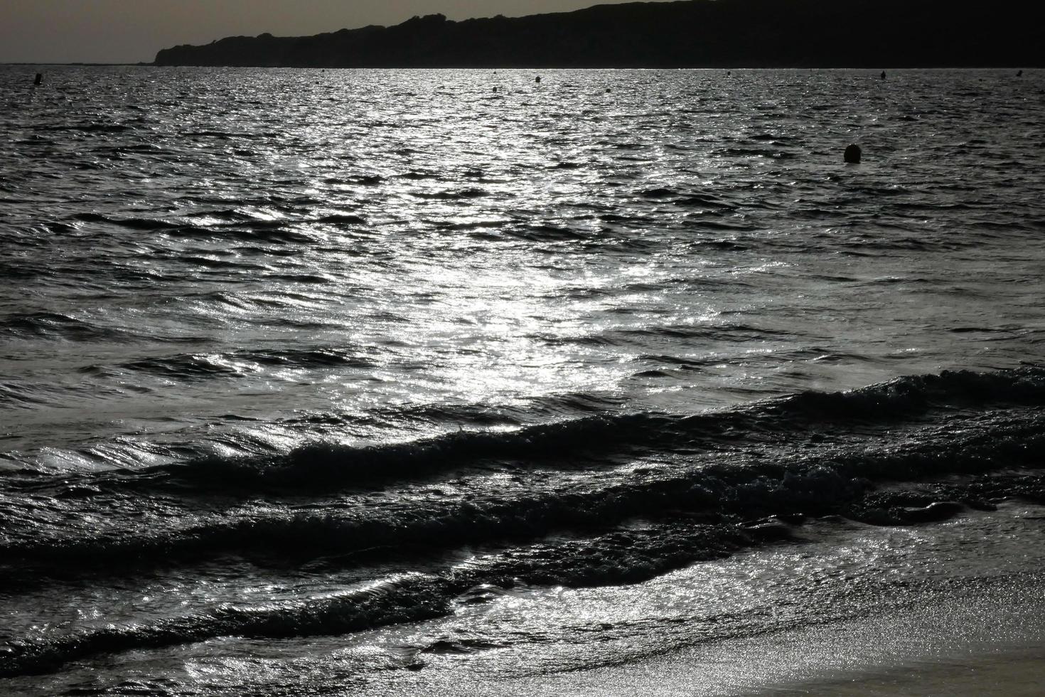 lonely, uncrowded beach with calm sea and small waves photo