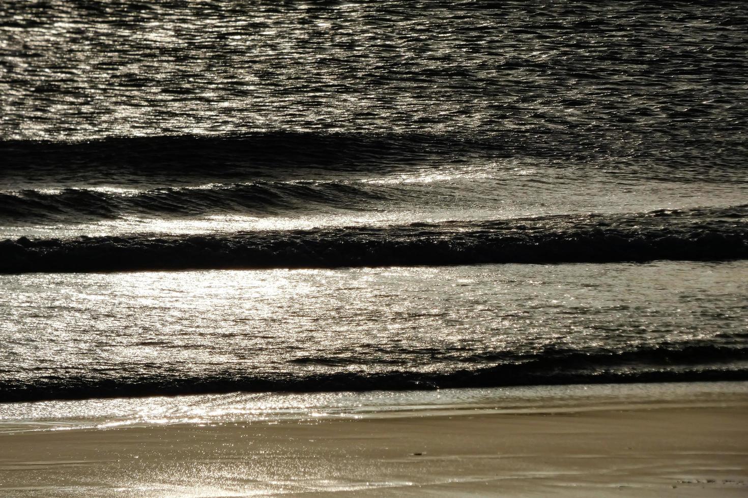 lonely, uncrowded beach with calm sea and small waves photo