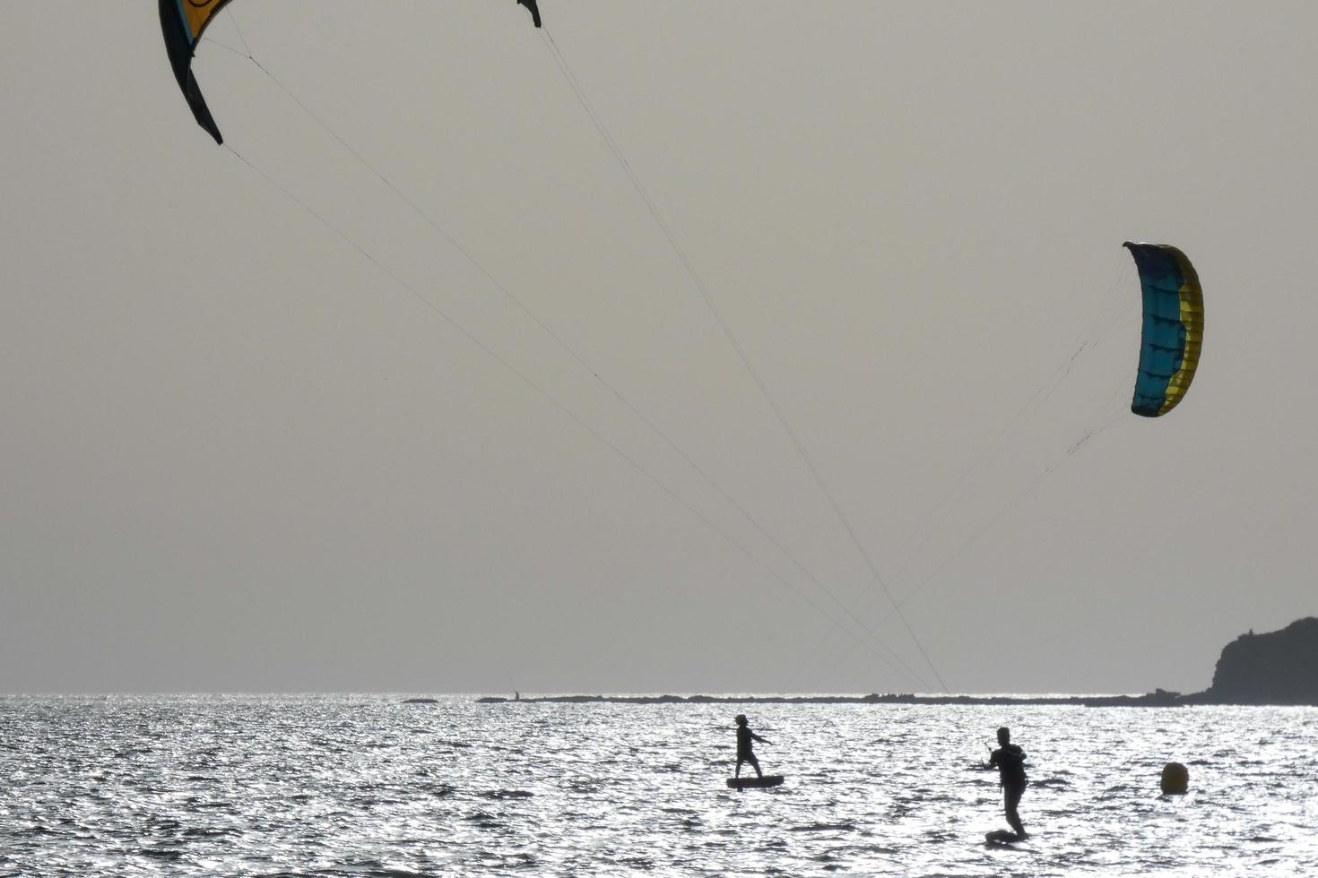 windsurfing, kitesurfing, water and wind sports powered by sails or kites photo