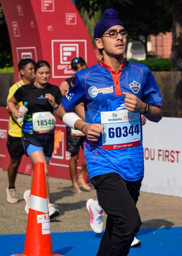 New Delhi, India - October 16 2022 - Vedanta Delhi Half Marathon race after covid in which marathon participants about to cross the finish line, Delhi Half Marathon 2022 photo