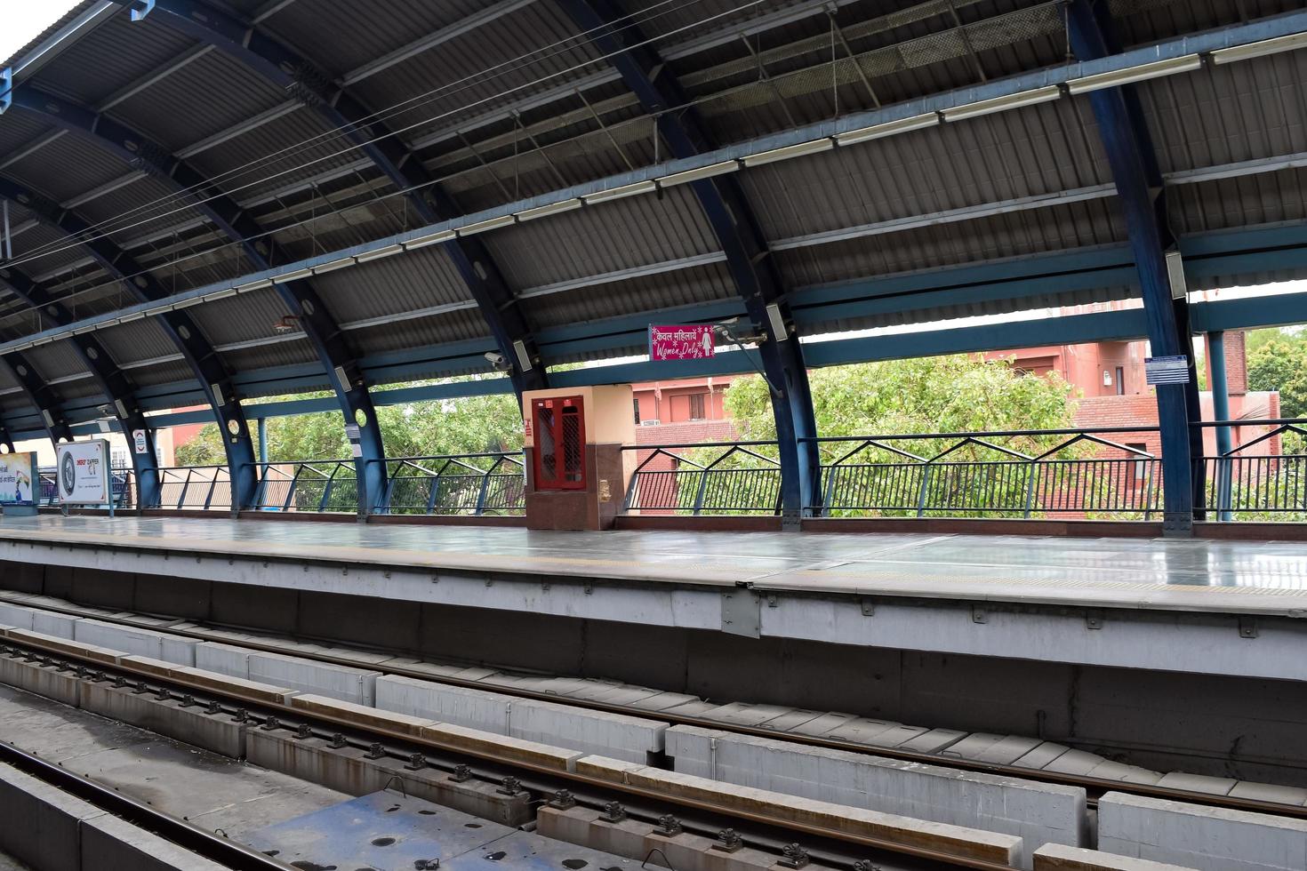 New Delhi India - June 21 2022 - Delhi Metro train arriving at Jhandewalan metro station in New Delhi, India, Asia, Public Metro departing from Jhandewalan station photo