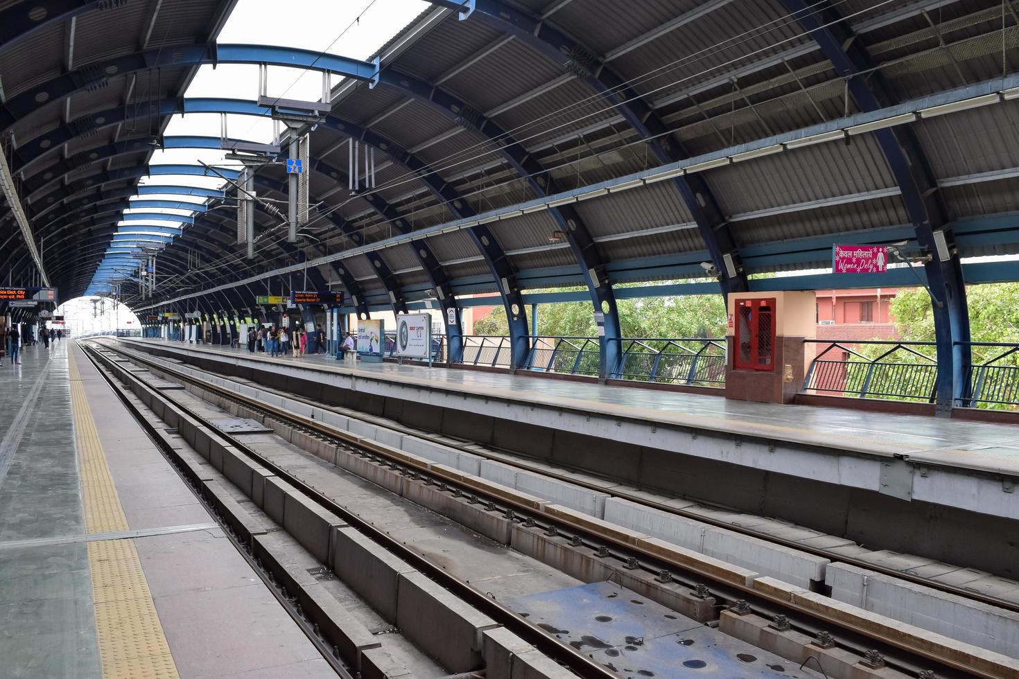 New Delhi India - June 21 2022 - Delhi Metro train arriving at Jhandewalan metro station in New Delhi, India, Asia, Public Metro departing from Jhandewalan station photo