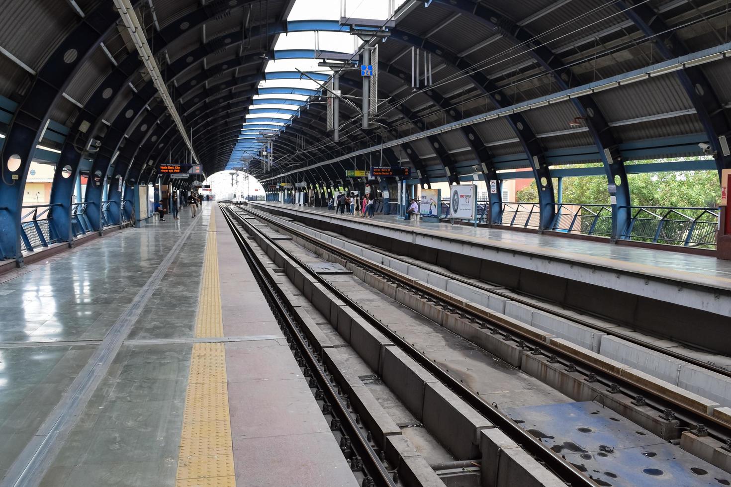 New Delhi India - June 21 2022 - Delhi Metro train arriving at Jhandewalan metro station in New Delhi, India, Asia, Public Metro departing from Jhandewalan station photo