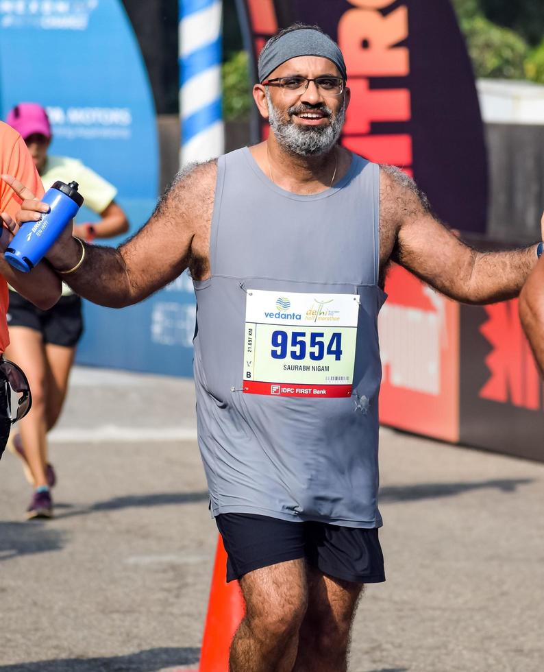 New Delhi, India - October 16 2022 - Vedanta Delhi Half Marathon race after covid in which marathon participants about to cross the finish line, Delhi Half Marathon 2022 photo