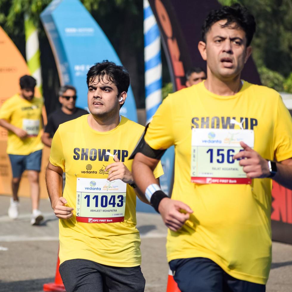 New Delhi, India - October 16 2022 - Vedanta Delhi Half Marathon race after covid in which marathon participants about to cross the finish line, Delhi Half Marathon 2022 photo