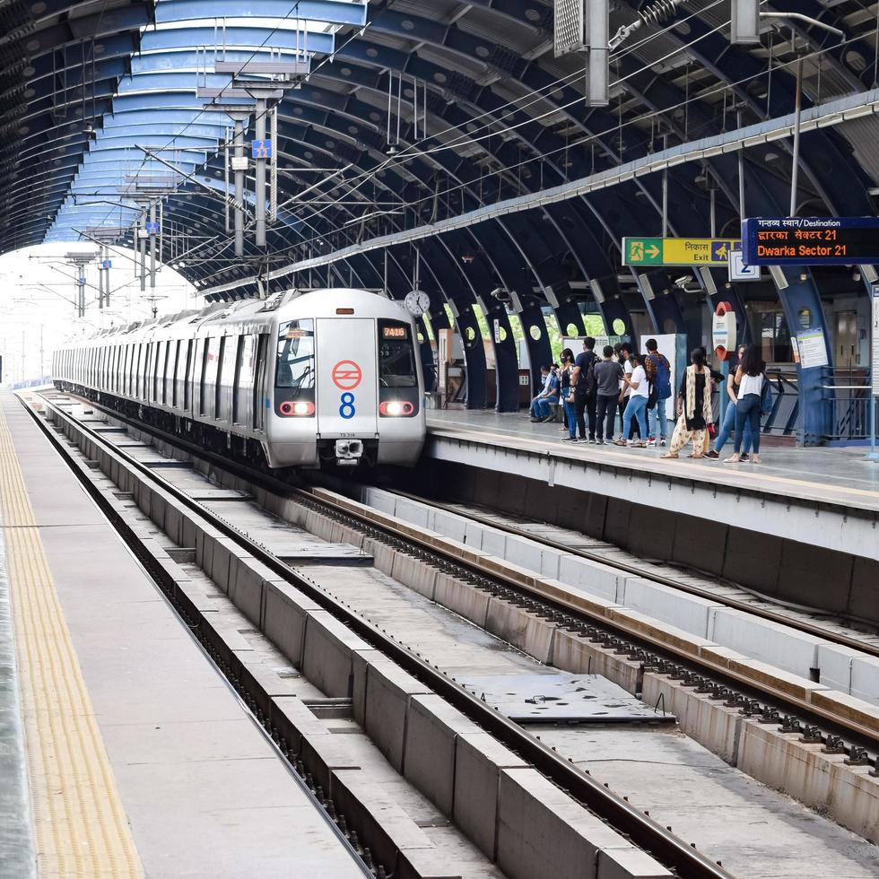 New Delhi India - June 21 2022 - Delhi Metro train arriving at Jhandewalan metro station in New Delhi, India, Asia, Public Metro departing from Jhandewalan station photo
