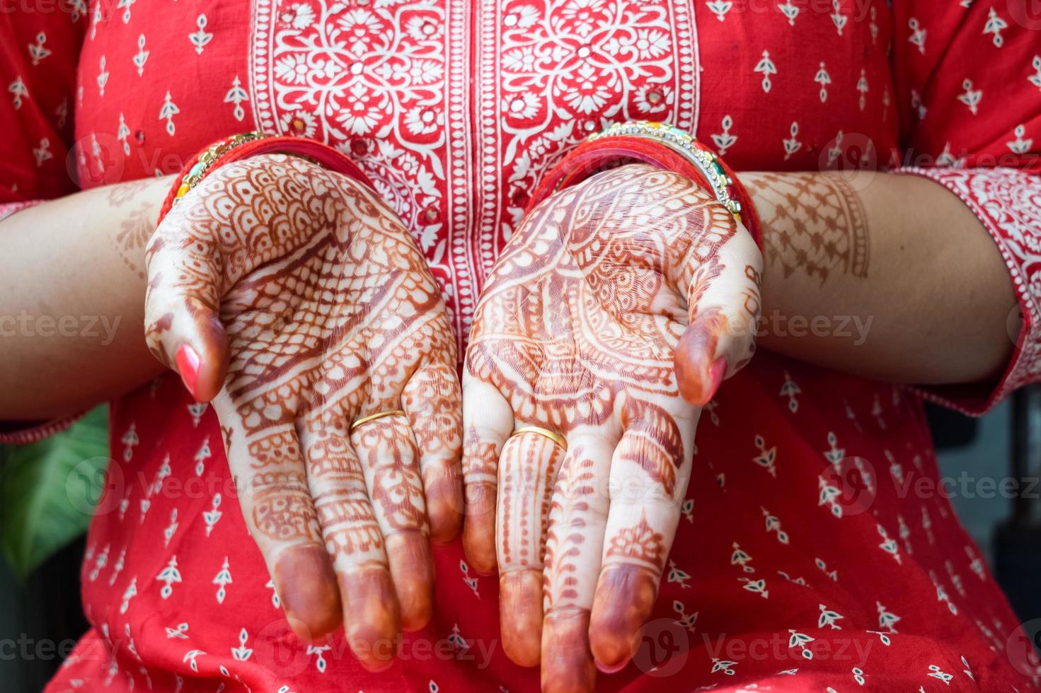 Beautiful woman dressed up as Indian tradition with henna mehndi design on her both hands to celebrate big festival of Karwa Chauth, Karwa Chauth celebrations by Indian woman for her husband photo