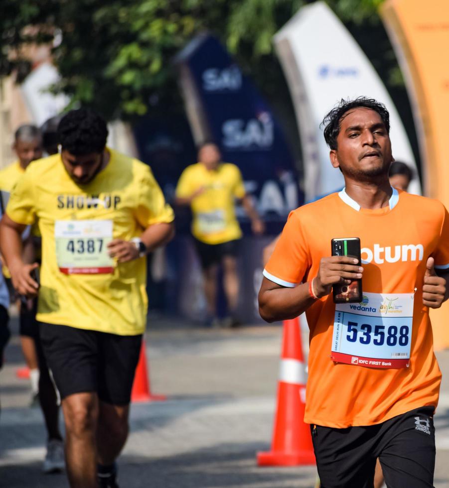 New Delhi, India - October 16 2022 - Vedanta Delhi Half Marathon race after covid in which marathon participants about to cross the finish line, Delhi Half Marathon 2022 photo