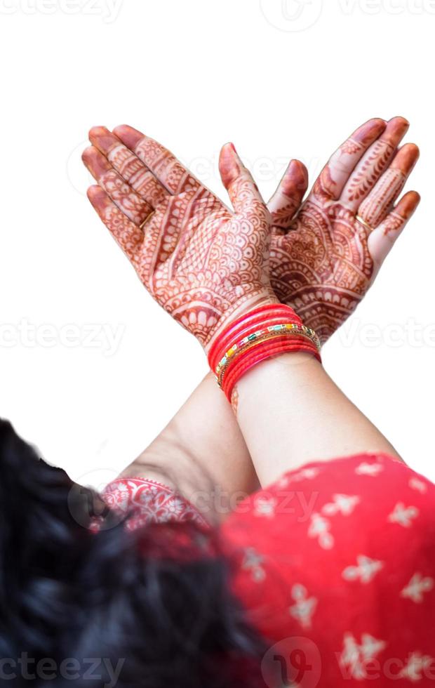 Beautiful woman dressed up as Indian tradition with henna mehndi design on her both hands to celebrate big festival of Karwa Chauth with plain white background photo