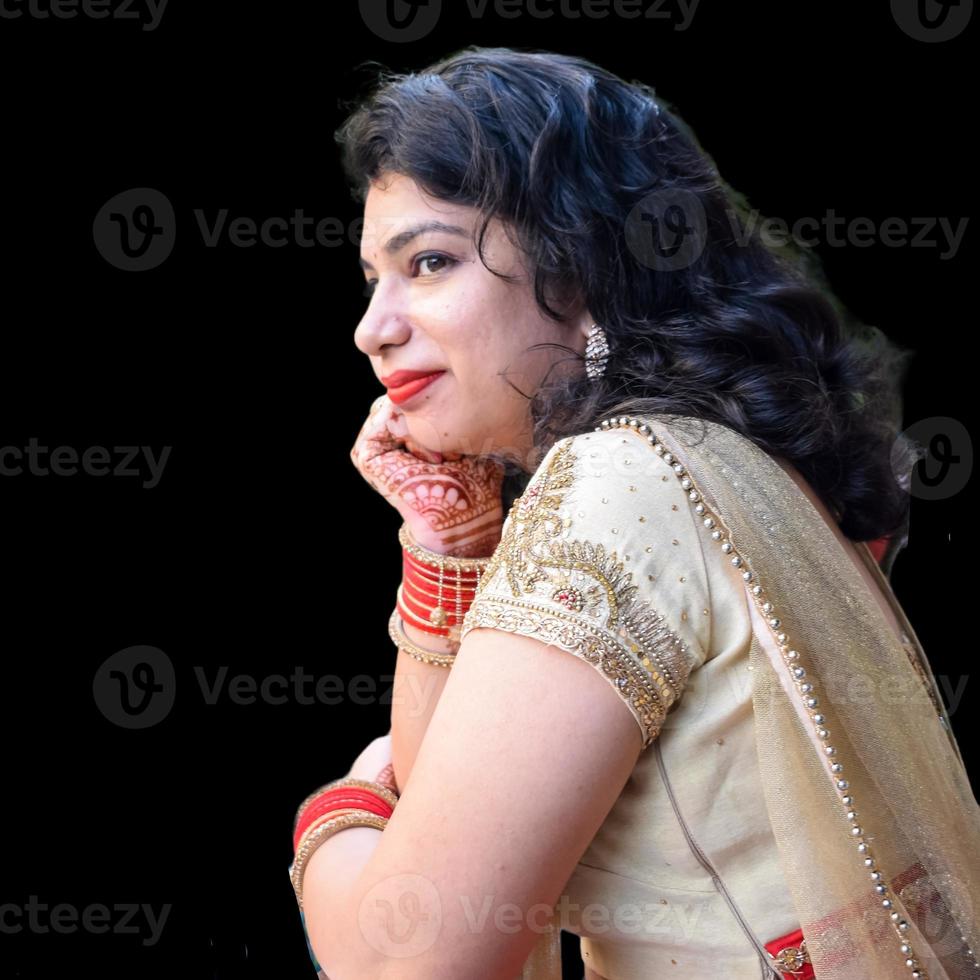 Beautiful woman dressed up as Indian tradition with henna mehndi design on her both hands to celebrate big festival of Karwa Chauth with plain white background photo