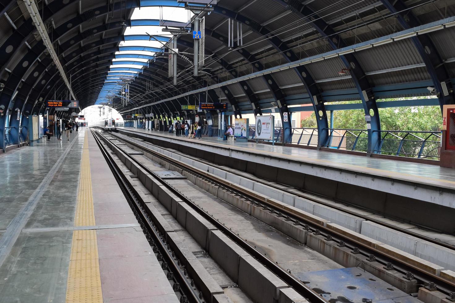 New Delhi India - June 21 2022 - Delhi Metro train arriving at Jhandewalan metro station in New Delhi, India, Asia, Public Metro departing from Jhandewalan station photo