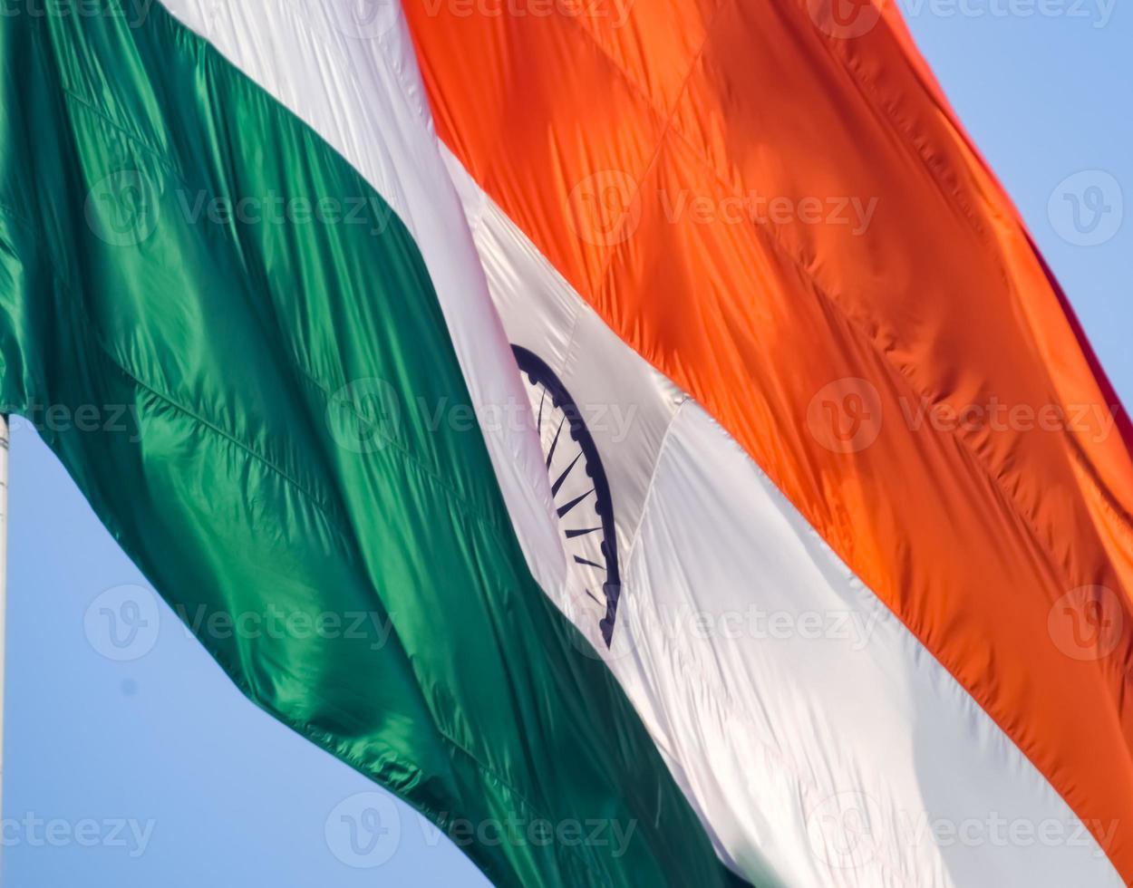 India flag flying high at Connaught Place with pride in blue sky, India flag fluttering, Indian Flag on Independence Day and Republic Day of India, tilt up shot, Waving Indian flag, Har Ghar Tiranga photo