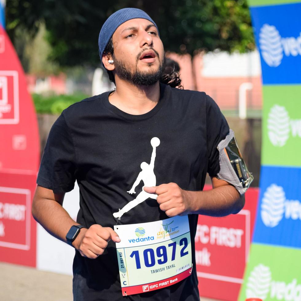 New Delhi, India - October 16 2022 - Vedanta Delhi Half Marathon race after covid in which marathon participants about to cross the finish line, Delhi Half Marathon 2022 photo