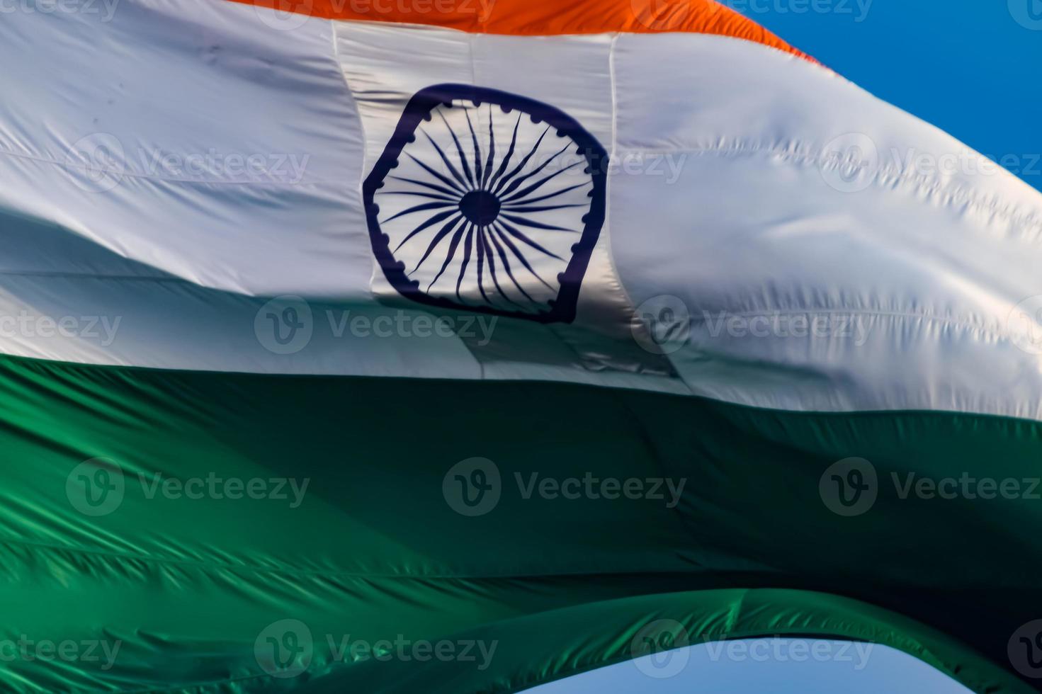 India flag flying high at Connaught Place with pride in blue sky, India flag fluttering, Indian Flag on Independence Day and Republic Day of India, tilt up shot, Waving Indian flag, Har Ghar Tiranga photo