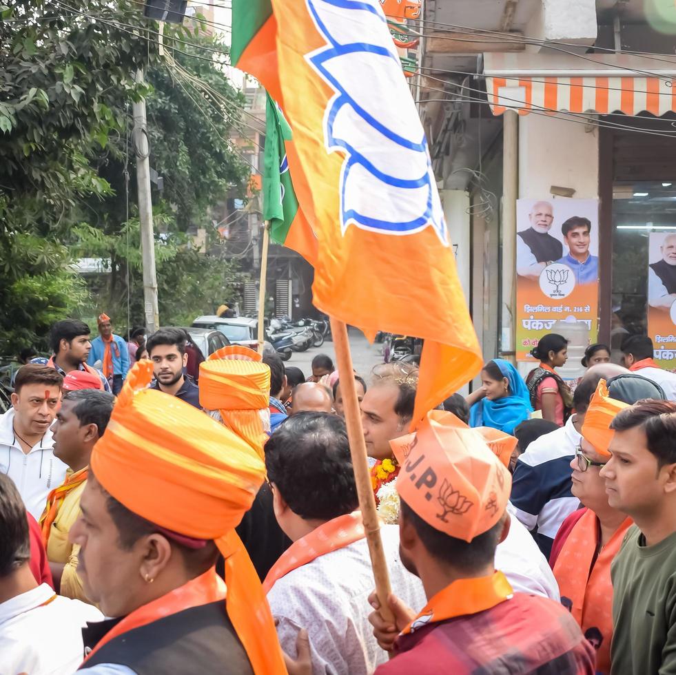Delhi, India, December 02 2022 - Bharatiya Janata Party BJP supporter during mega road show in support of BJP candidate Pankaj Luthara to file nomination papers ahead of MCD local body Elections 2022 photo
