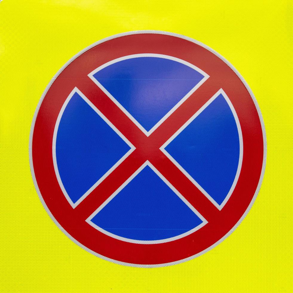 road sign parking is prohibited on a yellow background photo