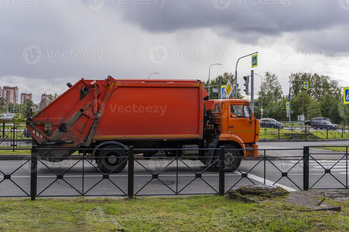 a garbage truck is driving through the city photo