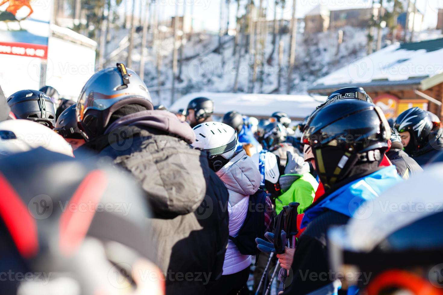People at ski lift, line of skiers and snowboarders photo