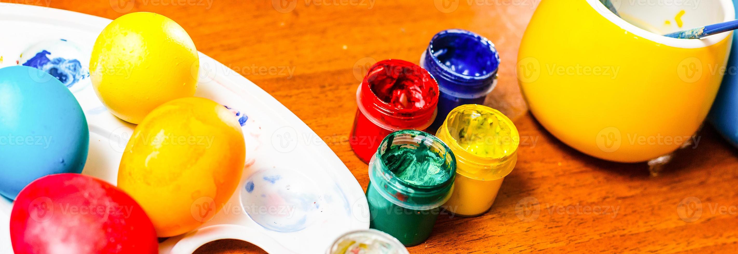 painting Easter eggs on table photo