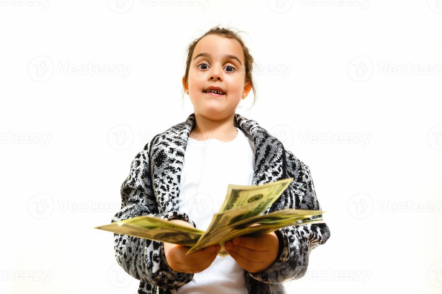 Beautiful little girl with money, isolated on white photo