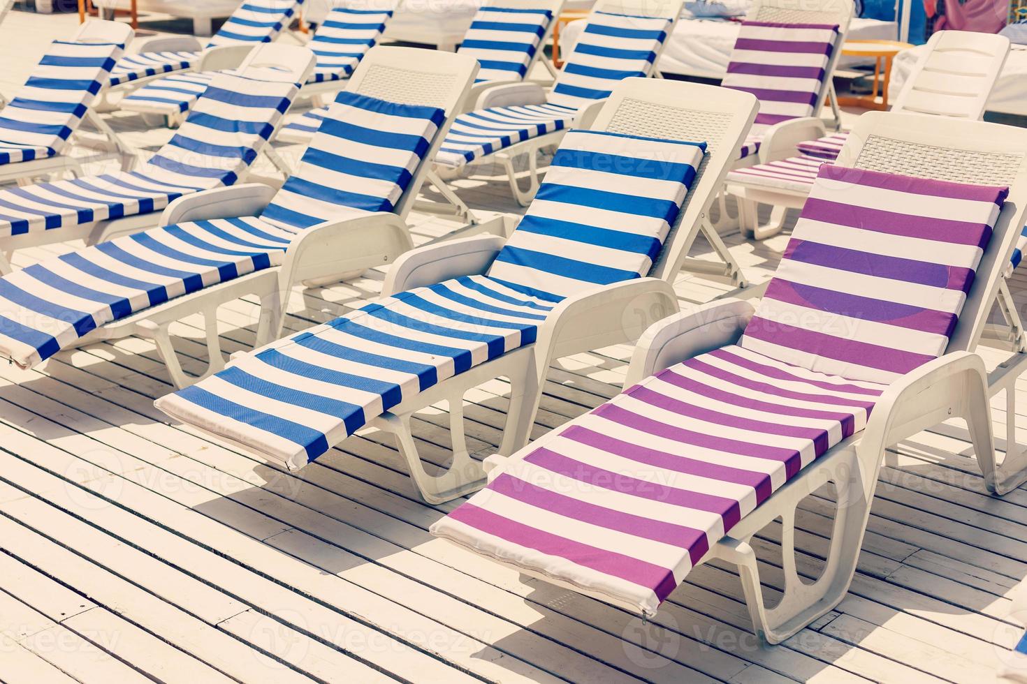 Blue deck chairs at the swimming pool photo