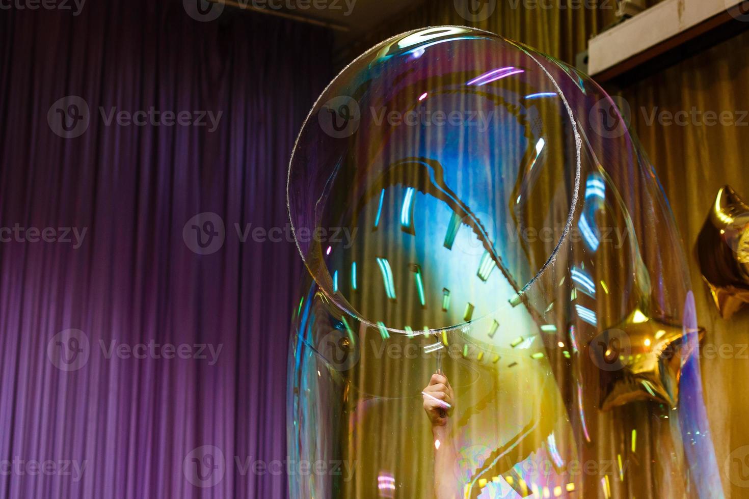 Artist blowing many soap bubble from his hands bubble show photo