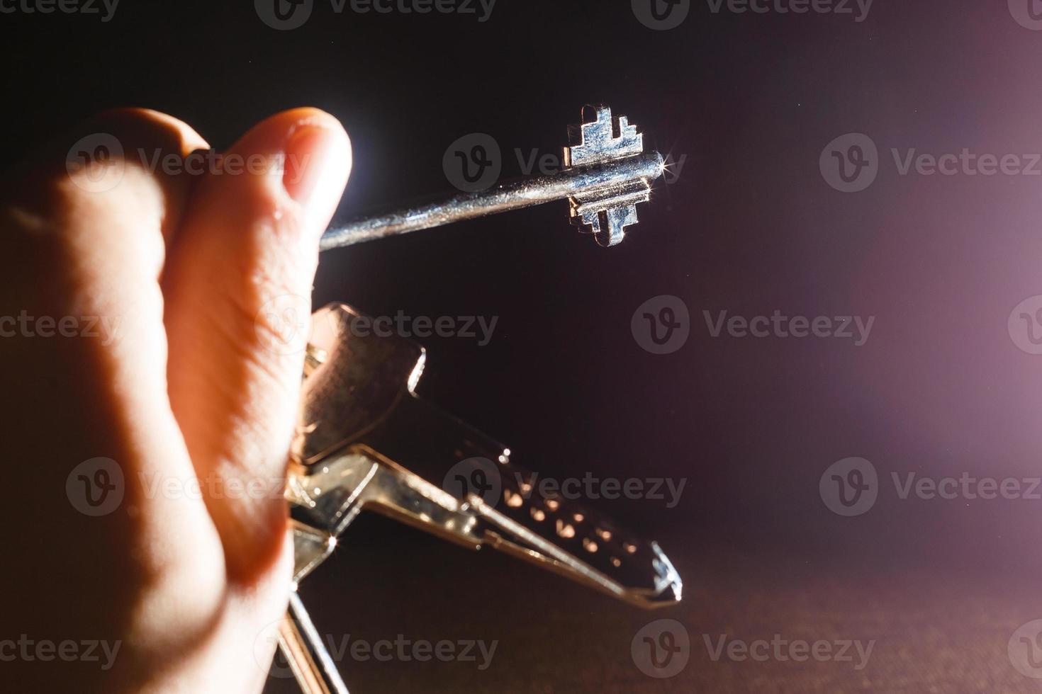 Key with key chain on hand on black background photo