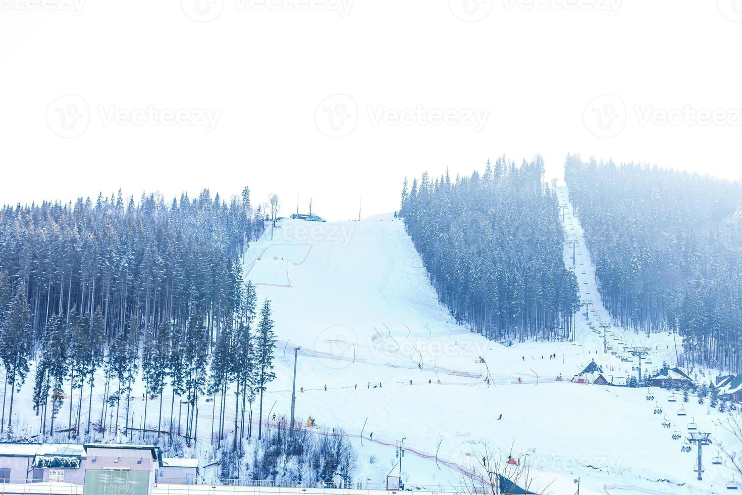 Panoramic view of sport resort for winter vacation - Skies with back light - Warm filter with original sun color tones photo