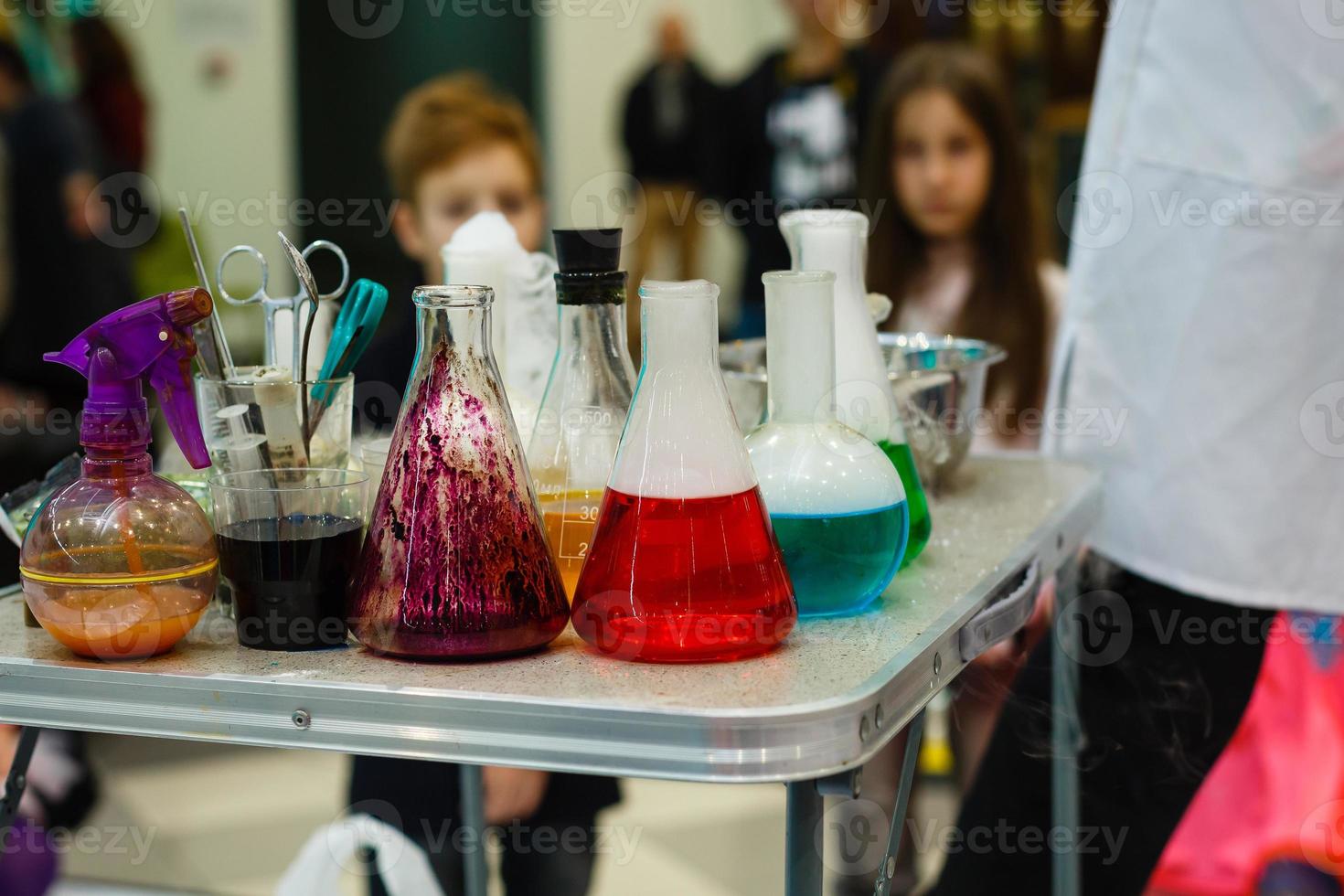 colored reagents in laboratory flasks photo