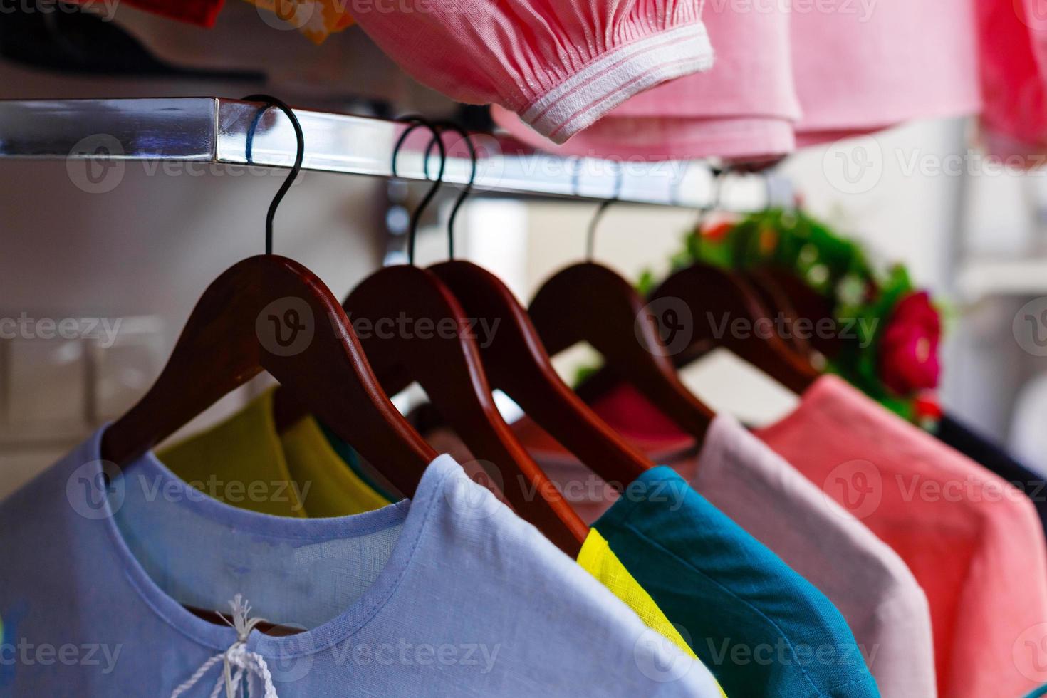 Fashion clothes on clothing rack bright colorful closet closeup of rainbow color choice photo