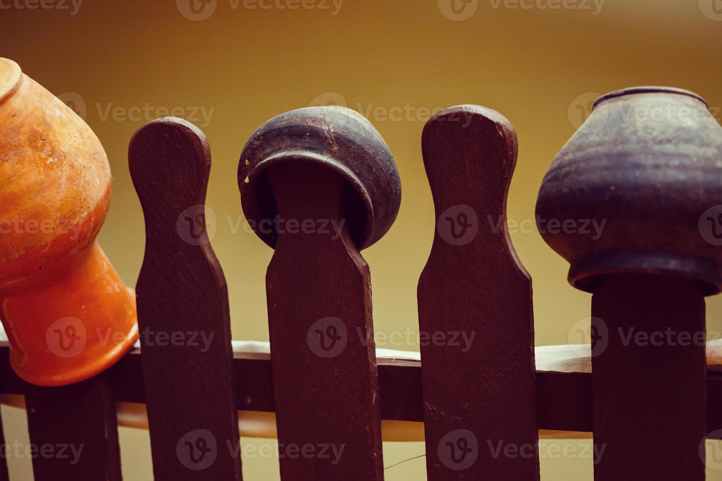 Landscape design clay pitchers pitchers on a woven wooden fence photo