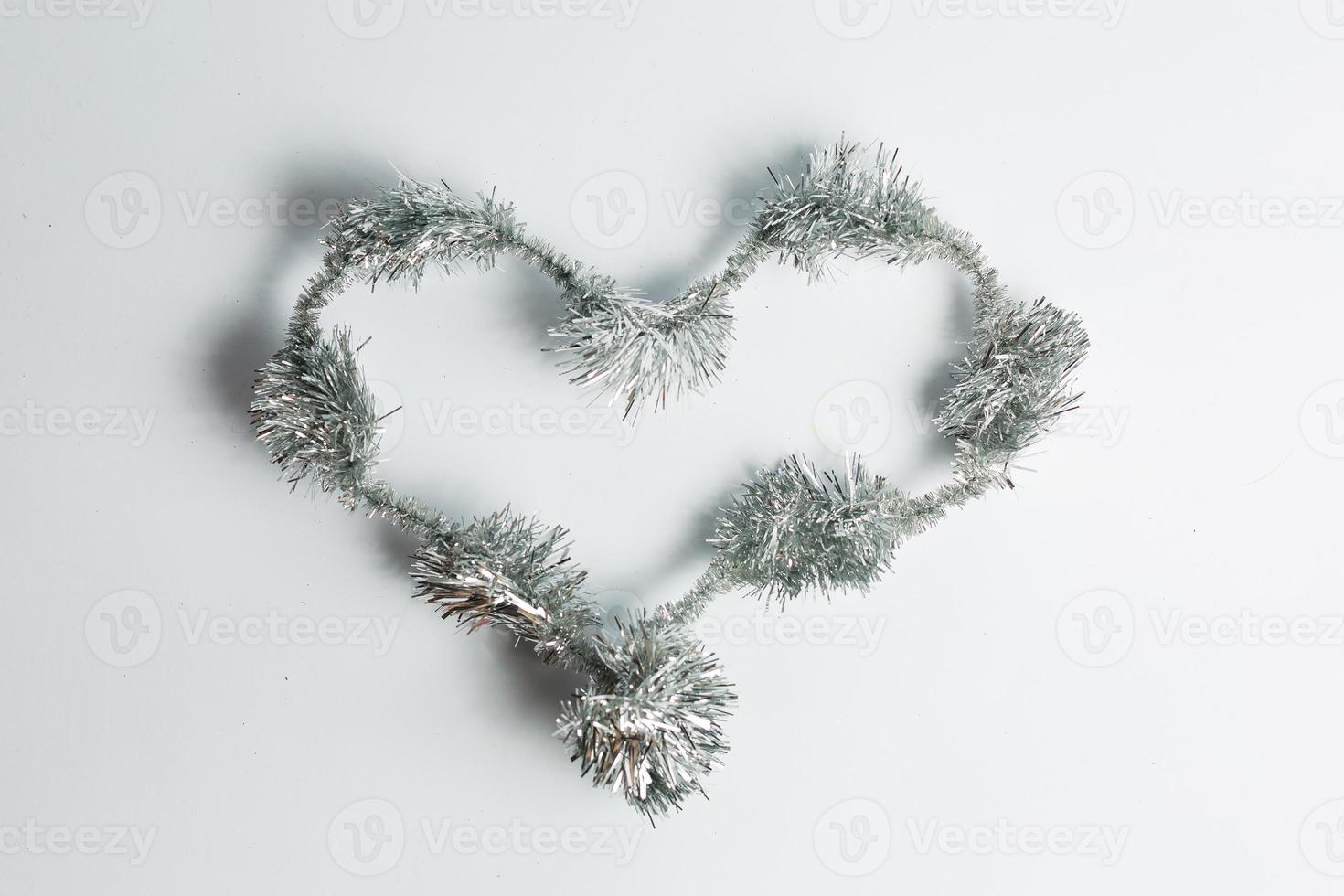 Christmas lights in the shape of heart on white background photo