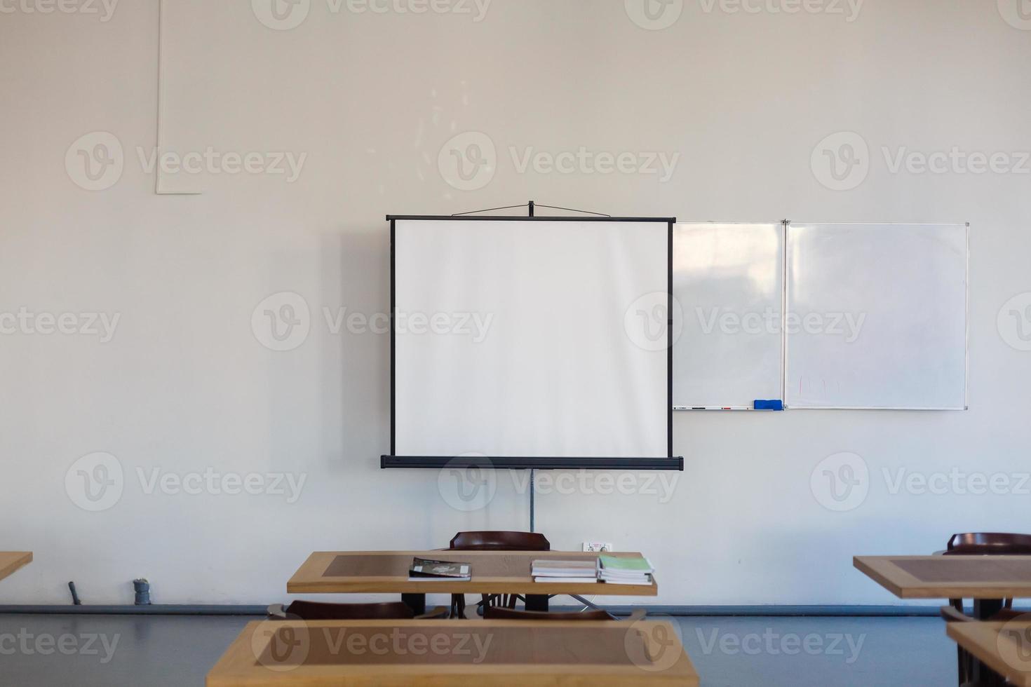 Inside the old classroom with board, desks and chairs. photo