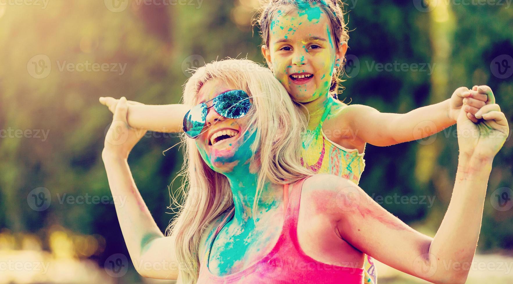 Mother and daughter playing at the festival of paints photo