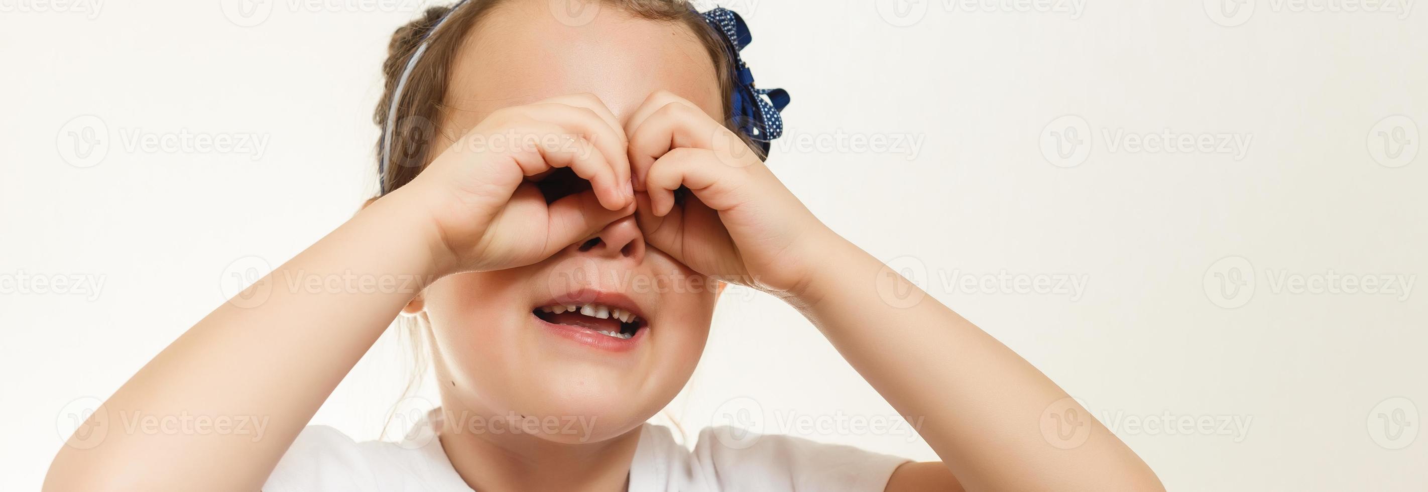 Little girl looking through imaginary binocular photo