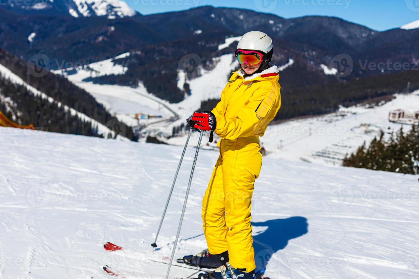 Attractive woman with ski over winter background photo