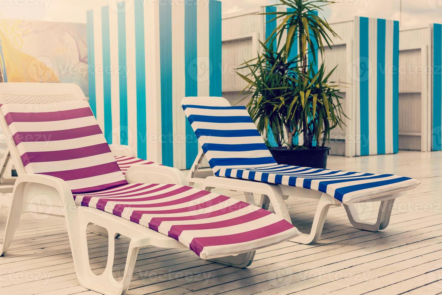 Blue deck chairs at the swimming pool photo