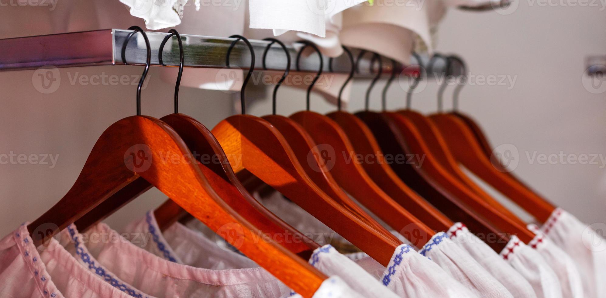 White clothes on wooden hangers photo