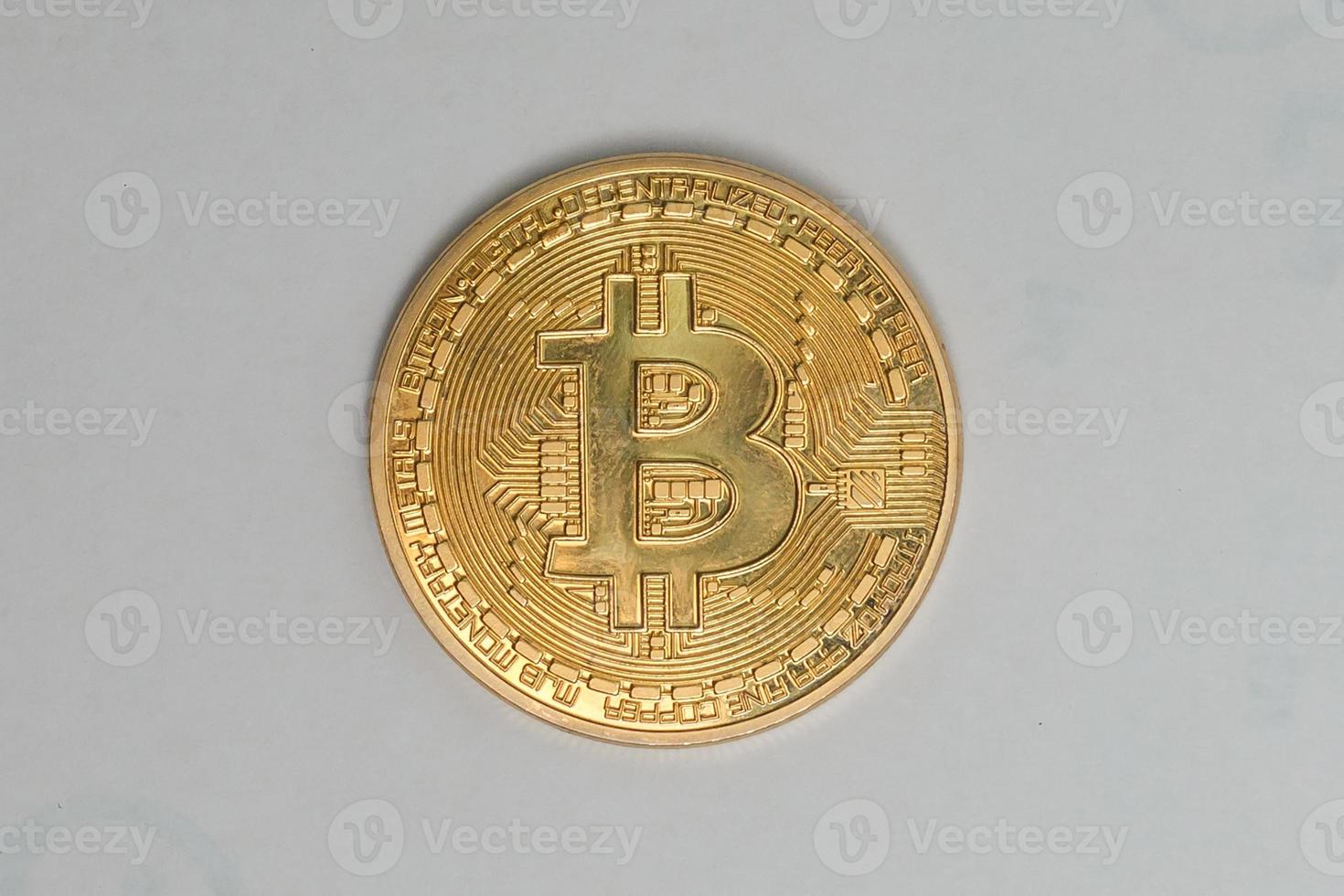 Gold coin of bitcoin on a gray background photo