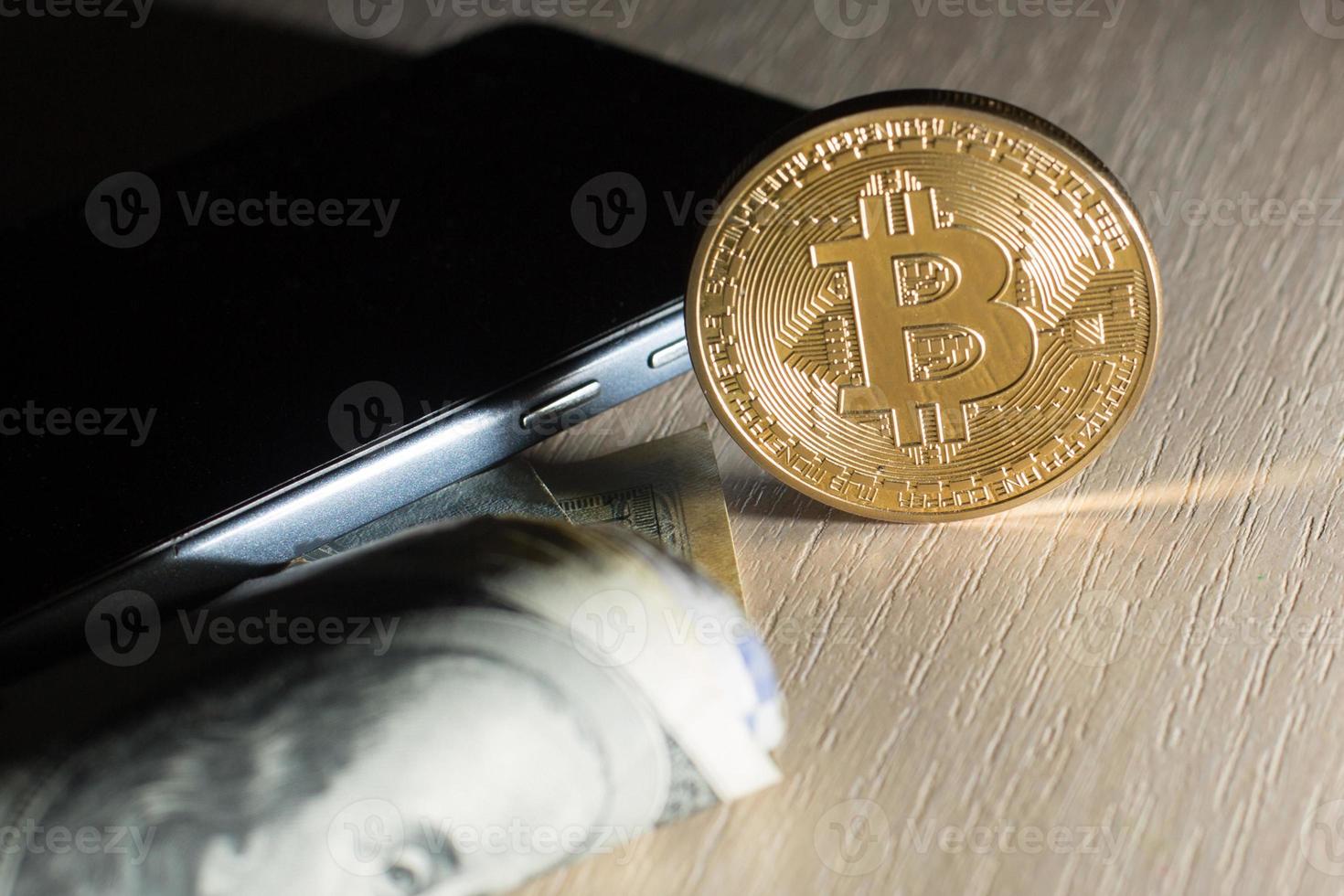 Concept with money american dollars bitcoin and mobile phone photo